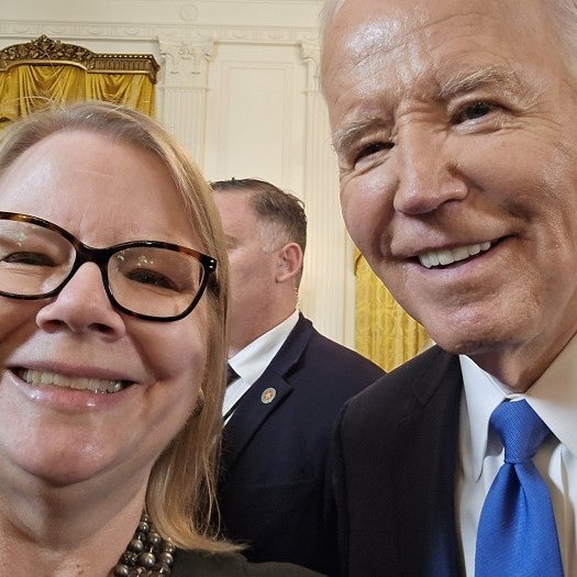 UCLA Executive MPH Professor Dr. Becky Yano poses with President Joe Biden at the White House.